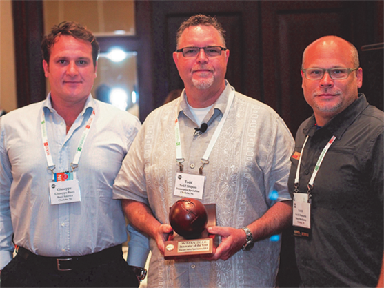 Todd Shapiro receives wooden globe award as the WMIA 2916 Innovator of the Year