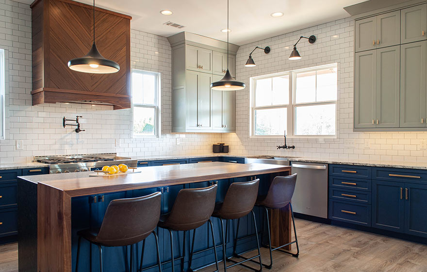 Right on trend, this navy blue and grey painted kitchen is accented perfectly with wood details.