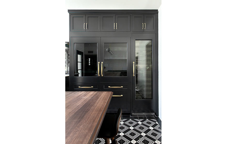 Dark and dramatic cabinets and plenty of natural light make this kitchen a show stopper.