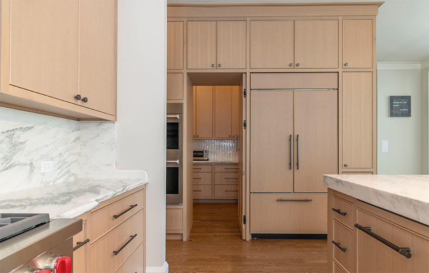 The popular Vienna style with beaded outside detail elevates this space featuring Rift White Oak veneer doors