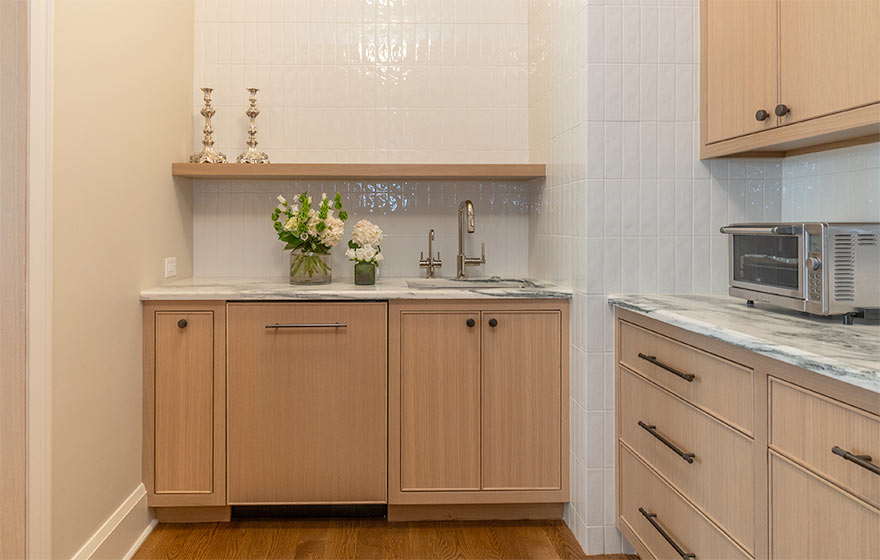 The popular Vienna style with beaded outside detail elevates this space featuring Rift White Oak veneer doors