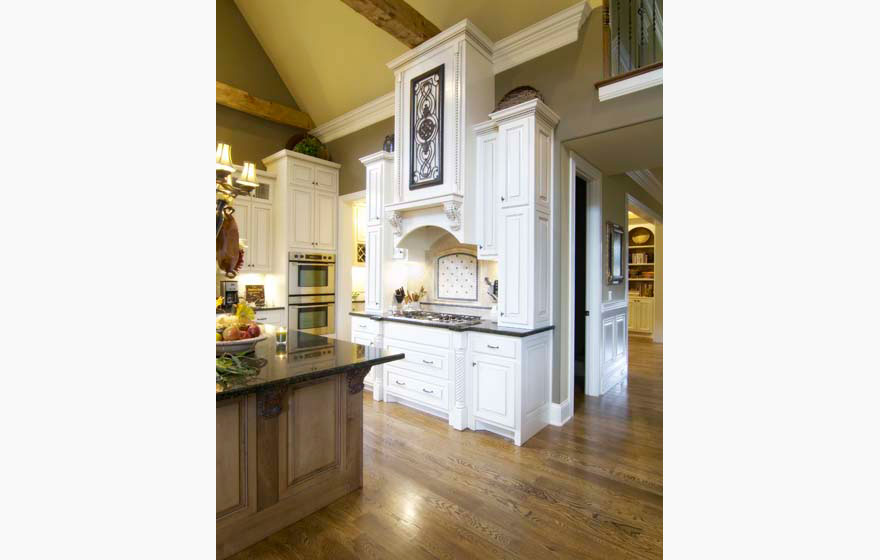 Tall cabinetry in a stunning arched ceiling kitchen creates a dramatic space.