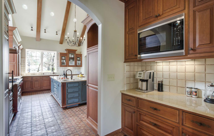 A customized door style is featured in this beautiful, bright kitchen.