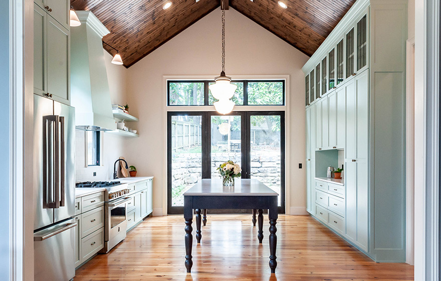 Stunning green painted cabinets perfectly accent the space