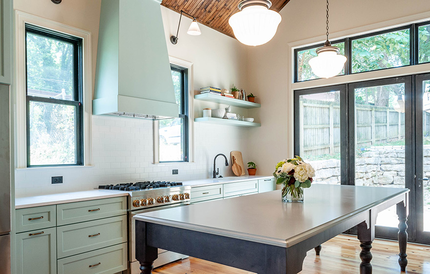 Stunning green painted cabinets perfectly accent the space