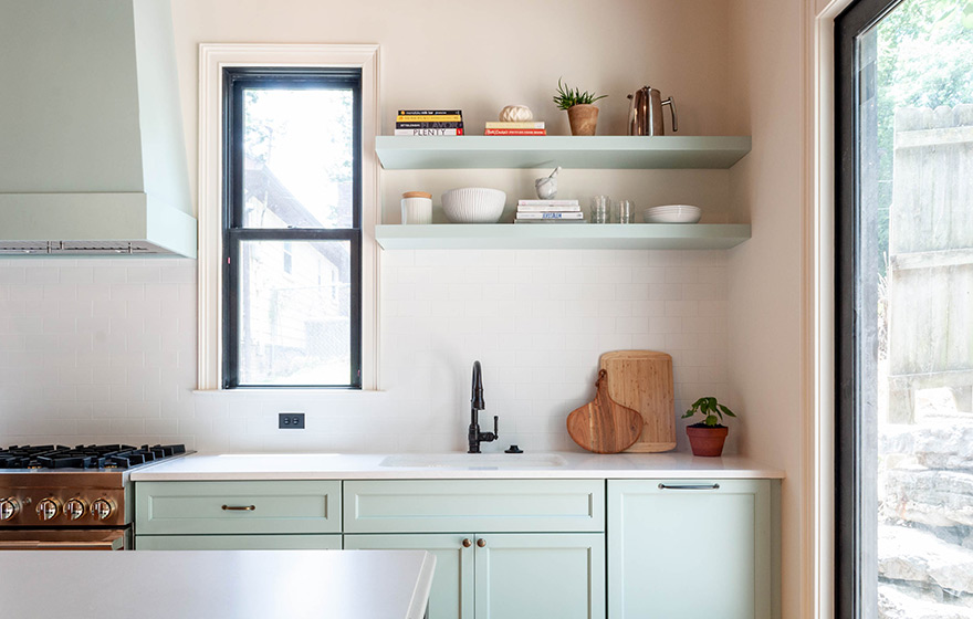 Stunning green painted cabinets perfectly accent the space