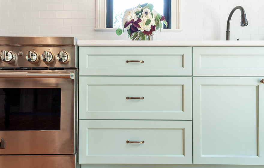 Stunning green painted cabinets perfectly accent the space