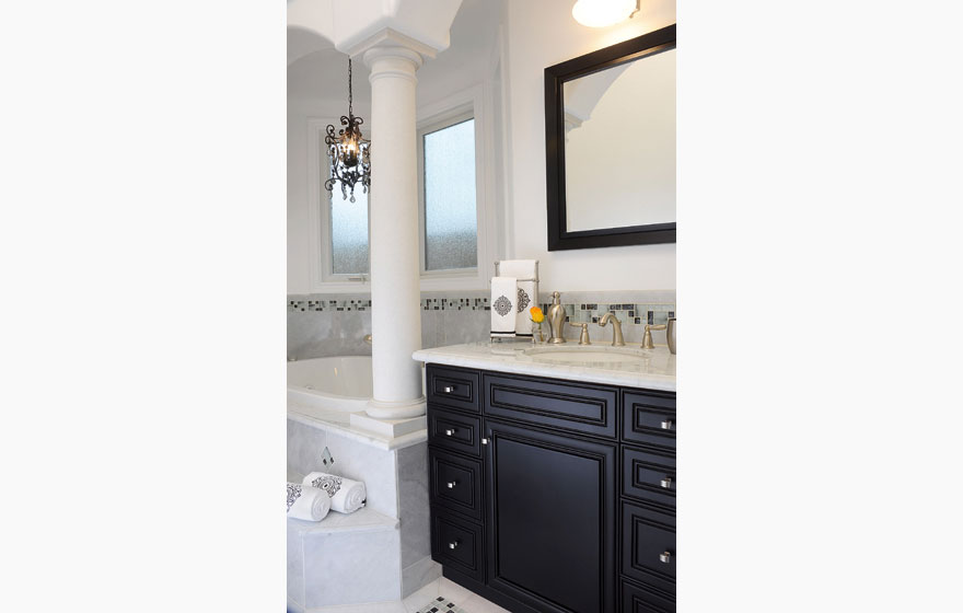 The contrast of dark cabinetry with light colored marble makes a dramatic statement.