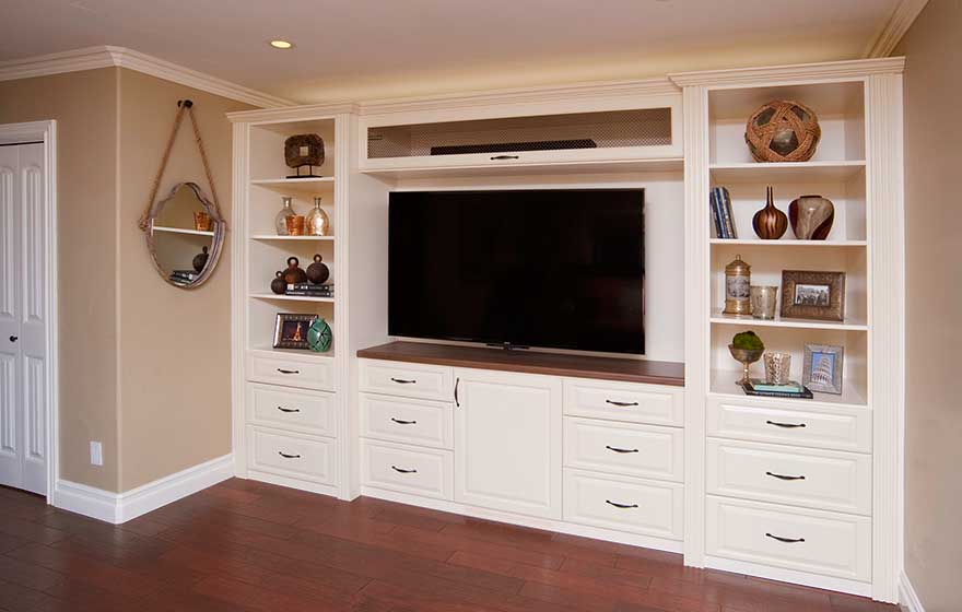 Functional storage and shelving beautifully fill this built-in guest room entertainment center.
