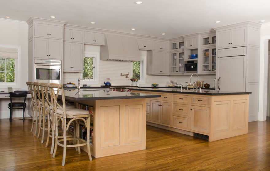 Rift Sawn White Oak pairs with painted cabinetry for a chic look in this large kitchen featuring dual islands.