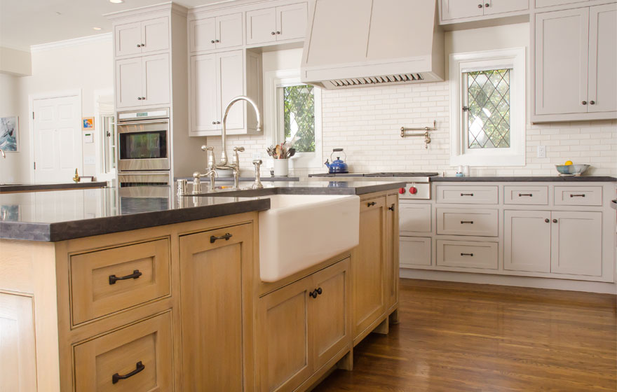 Rift Sawn White Oak pairs with painted cabinetry for a chic look in this large kitchen featuring dual islands.