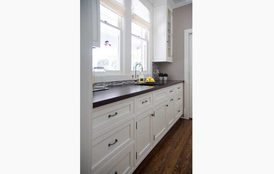 Off the kitchen area, this butlers pantry offers excellent storage space.