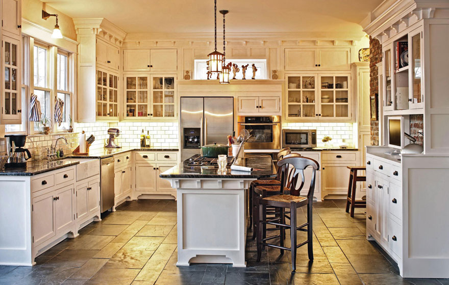 This inviting space uses white painted cabinetry to keep the room open and airy so it can meet the demand of being the hub of family activity.