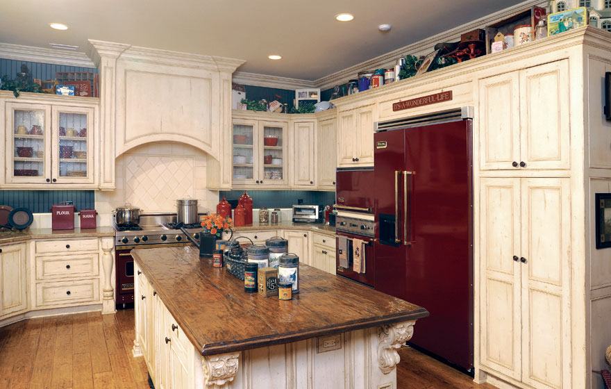 A large island and the tops of upper cabinets become a perfect home for containers and treasures to add a stylized look.