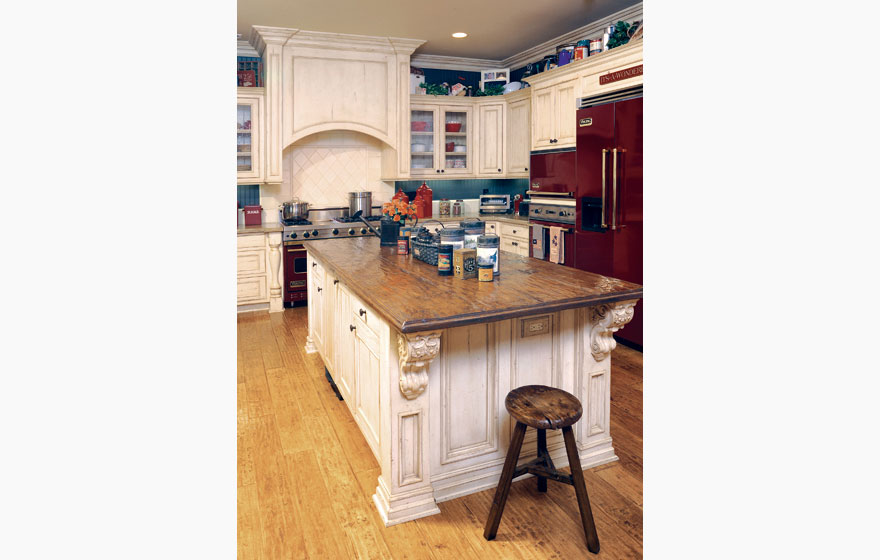 A large island and the tops of upper cabinets become a perfect home for containers and treasures to add a stylized look.