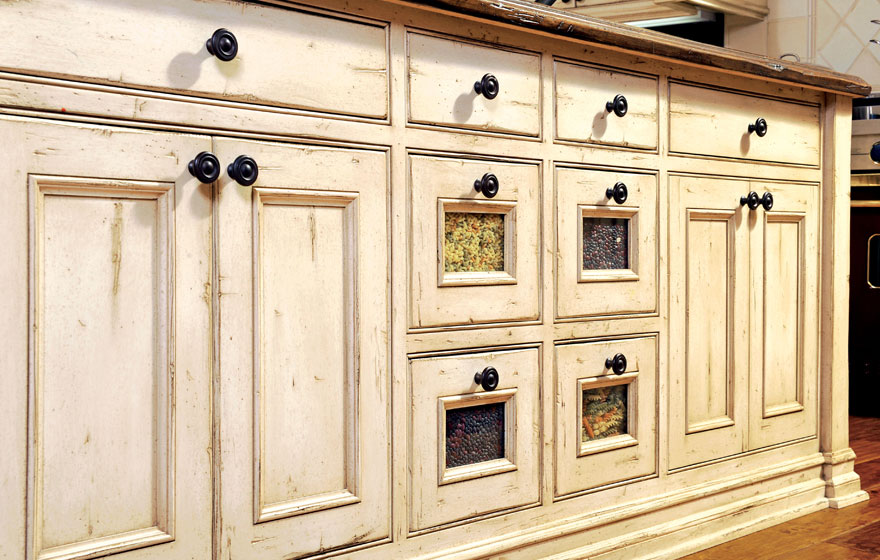 A large island and the tops of upper cabinets become a perfect home for containers and treasures to add a stylized look.