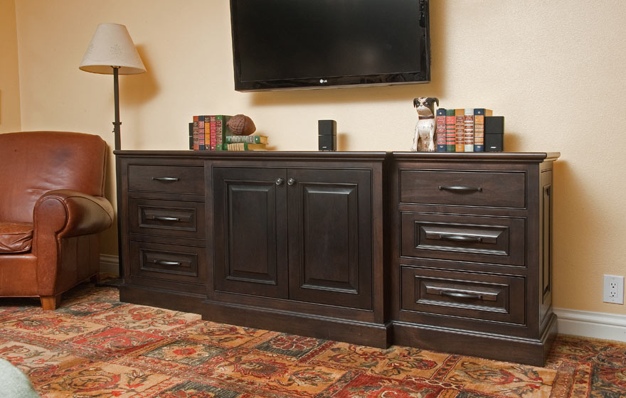 A custom applied molding door is displayed in this furniture piece, perfect for entertainment systems and display.