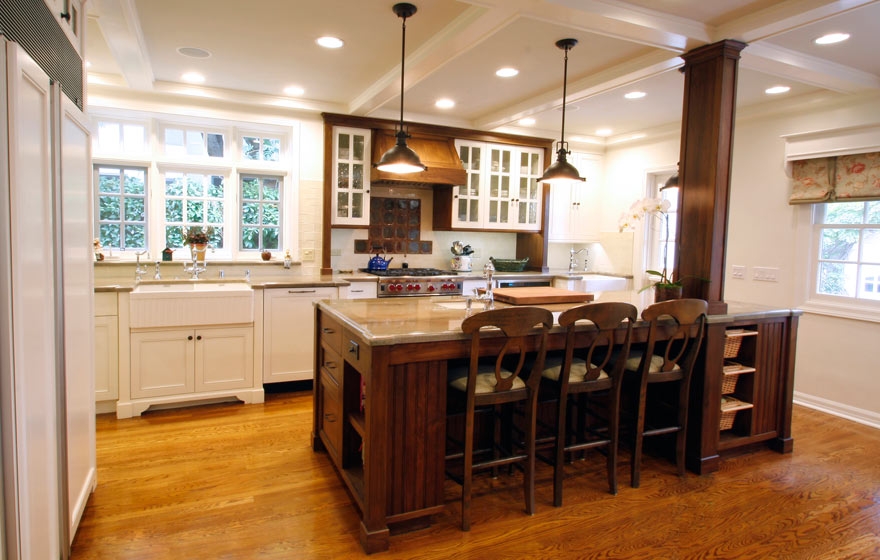 Striking Walnut wood perfectly accents this impressive kitchen full of french lite doors and interesting details.