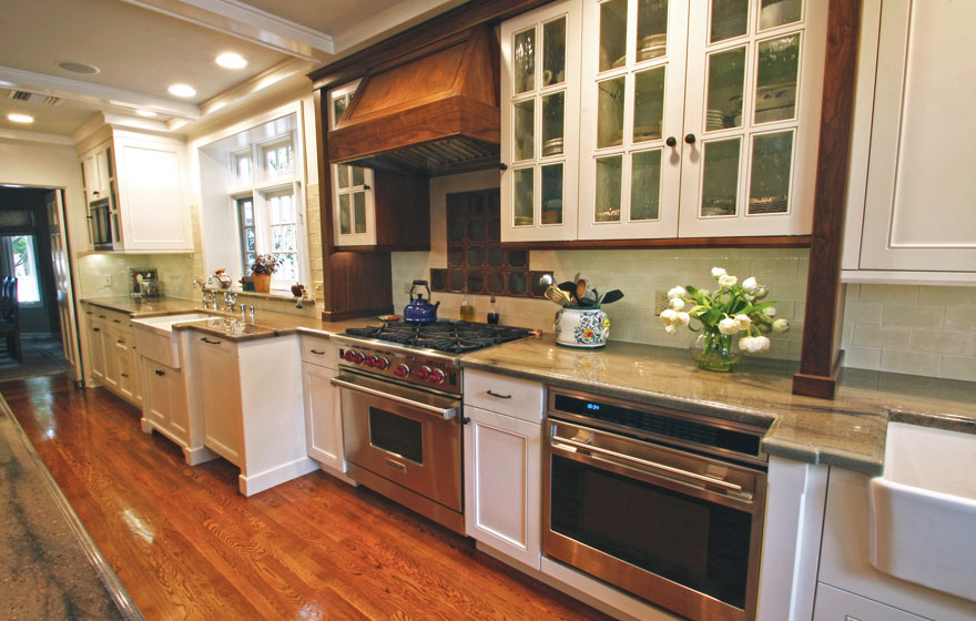 Striking Walnut wood perfectly accents this impressive kitchen full of french lite doors and interesting details.