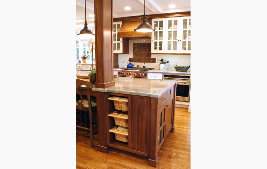 Striking Walnut wood perfectly accents this impressive kitchen full of french lite doors and interesting details.