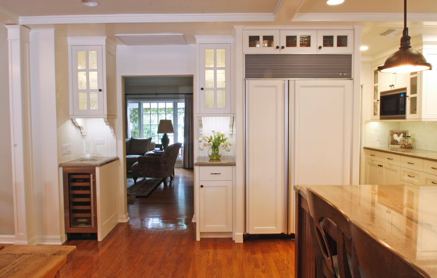 Striking Walnut wood perfectly accents this impressive kitchen full of french lite doors and interesting details.