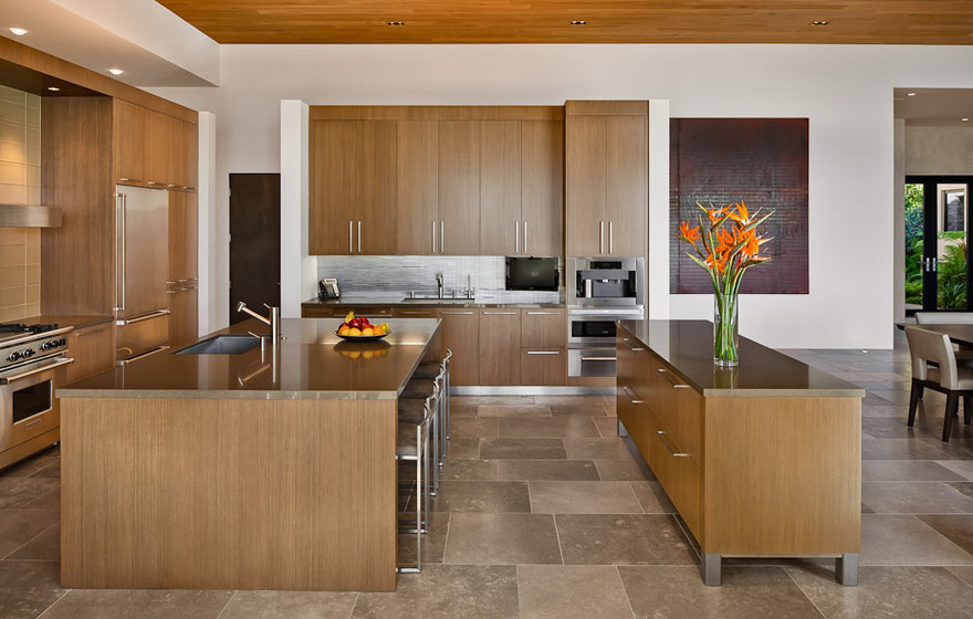 Wood veneer creates a smooth, classy look in this contemporary kitchen.