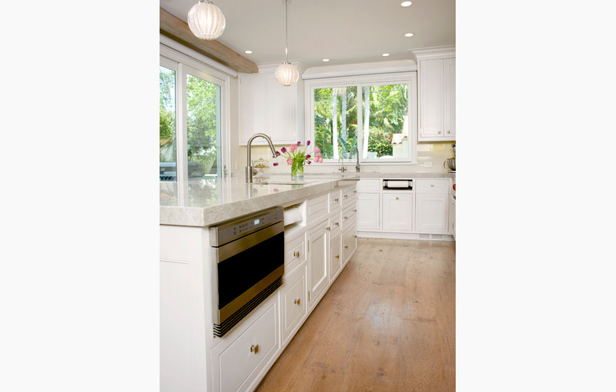 Custom designed wood cabinet doors were used in this stunning kitchen and dining space to bring a truly high end look.