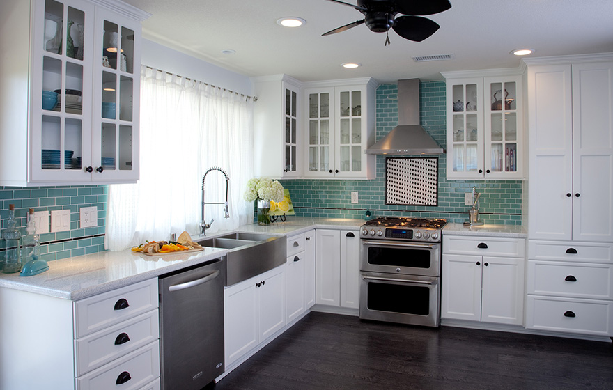 Clean and crisp cabinets pair well with the splash of color in the backsplash.