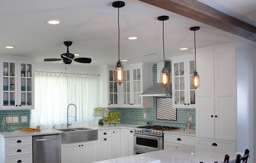 Clean and crisp cabinets pair well with the splash of color in the backsplash.